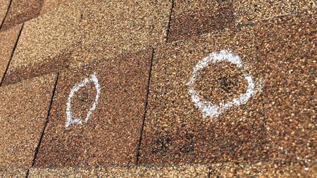 Hail damage to a roof in Northern Colorado located by Custom Exteriors during a roof inspection