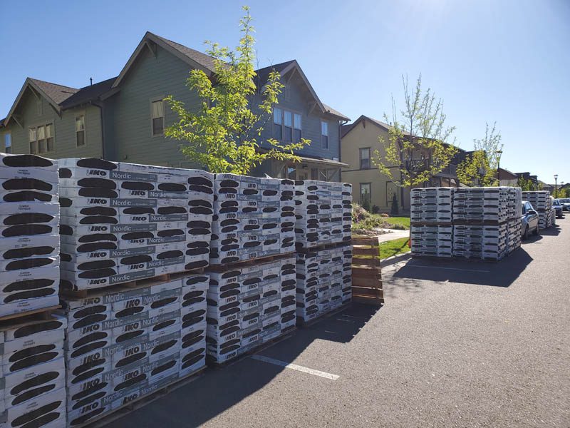 Shingles waiting to be installed at a multi-family roof replacement by Custom Exteriors