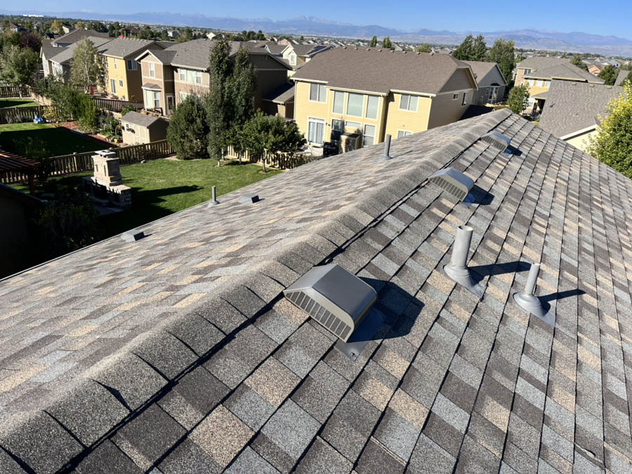 Residential roofing contractor in Loveland replacing asphalt shingle roof