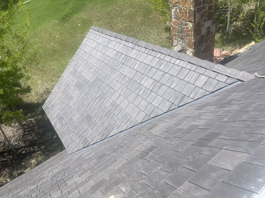 Loveland roofing company installing synthetic shingles on a roof replacement