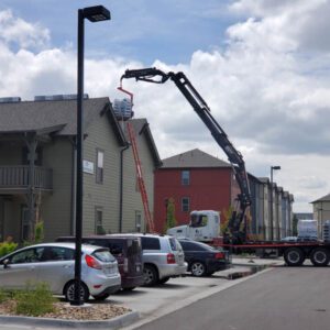 Exterior upgrades for rental properties showing a roof being replaced on a multi-family buidling