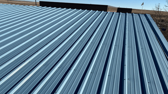 A metal roof replacement by Custom Exteriors, and tips on how to save money on a commercial roof replacement