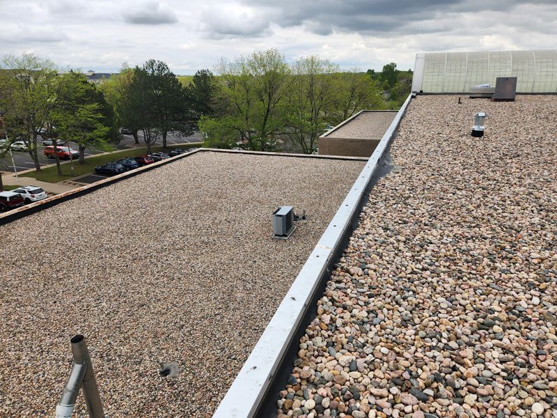 Commercial roof maintenance by Custom Exteriors, a commercial roofing company