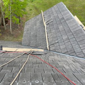 Evergreen roofing company, Custom Exteriors using synthetic, fire-resistant shingles to replace a roof in the Colorado foothills