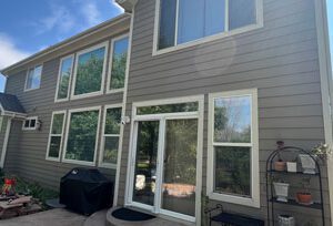 Evergreen window replacement company, Custom Exteriors, replacing the windows and glass doors on a local home