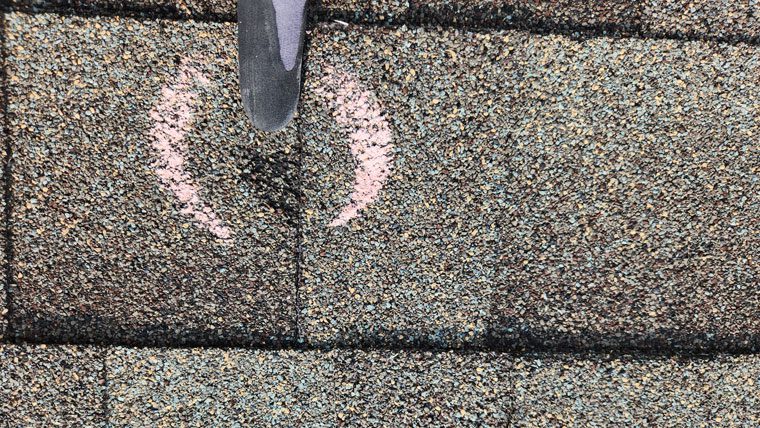 Hail damage to roof discovered during roof inspection in Northern Colorado by hail damage roofing contractor, Custom Exteriors