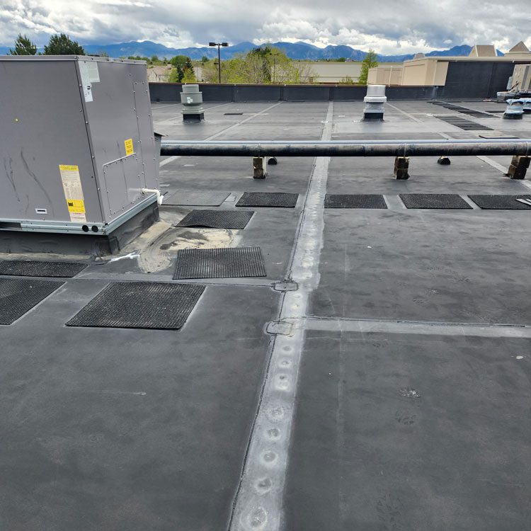 Flat roof replacement by Custom Exteriors, a commercial roofing company in Colorado