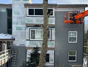 Commercial siding company, Custom Exteriors installing siding on a Colorado mountain commercial property