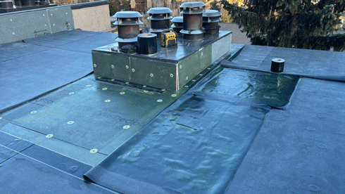 Commercial-roof-replacement - Custom Exteriors, LLC Commercial roofing company, Custom Exteriors midway through a flat commercial roof replacement in Vail, Colorado