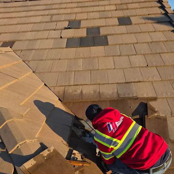The residential roofing team is installing new roof tiles after a storm caused the roof to develop a leak. This is one of our roofers during the testing process.
