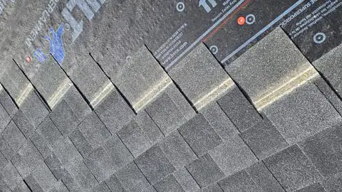 Shingles installation - Custom Exteriors, LLC Shingles being installed by the roofing team at Custom Exteriors on a home in Berthoud.