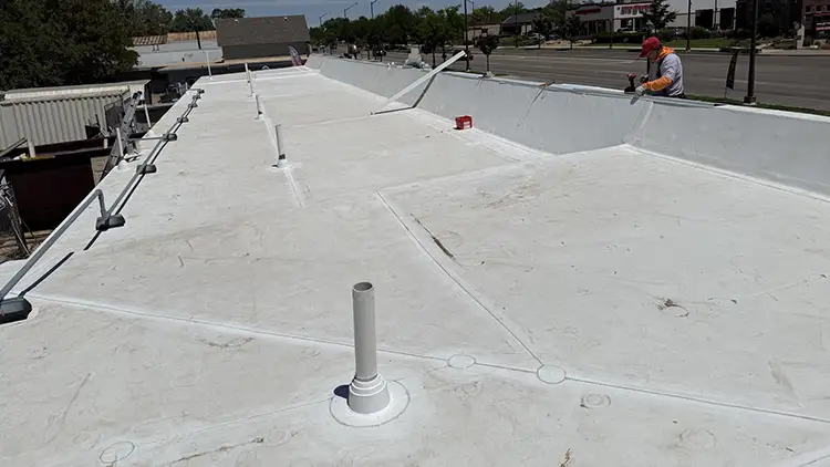The commercial roof installation crew doing repairs on a flat roof in Fort Collins.