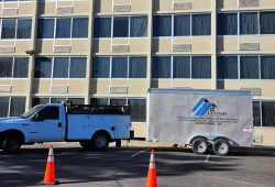The Custom Exteriors trailer in front of a hotel in Denver that Custom Exteriors was doing an extensive exterior renovation on.